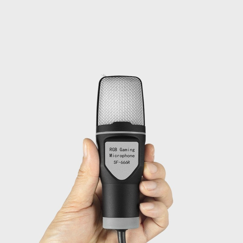 Hand holding an RGB gaming microphone with a white background