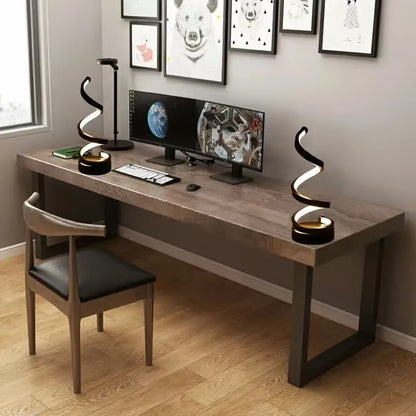 Modern home office with a wooden desk, chair, and computer setup.
