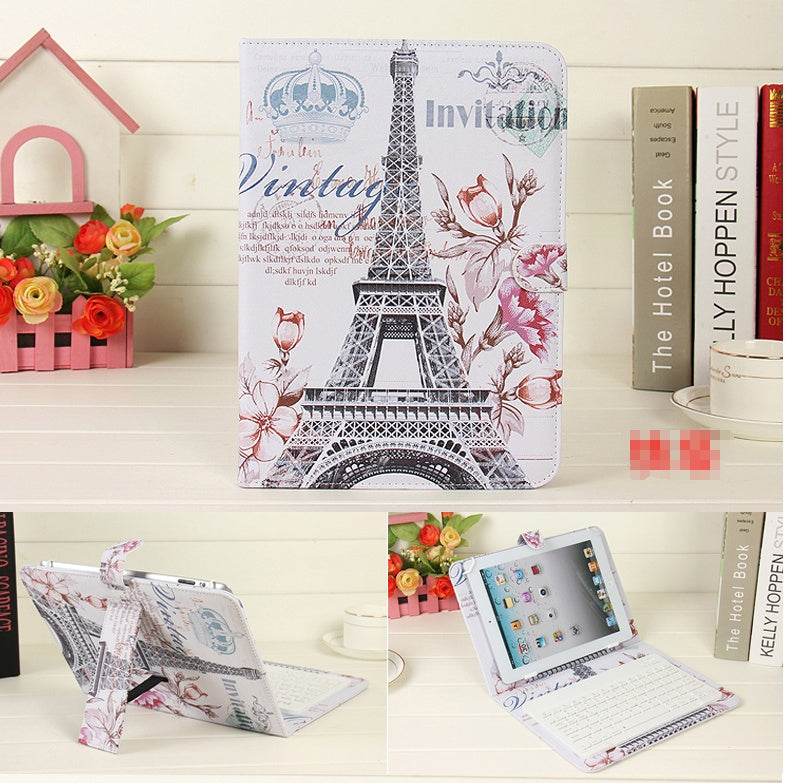 Tablet case with Eiffel Tower design on a shelf with books and flowers