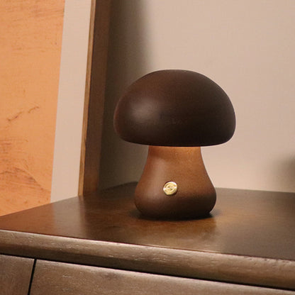 Mushroom-shaped lamp on a wooden surface with a warm glow