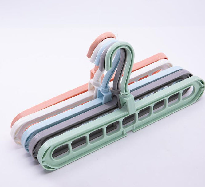 Set of colorful plastic hangers on a white background