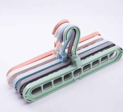 Set of colorful plastic hangers on a white background