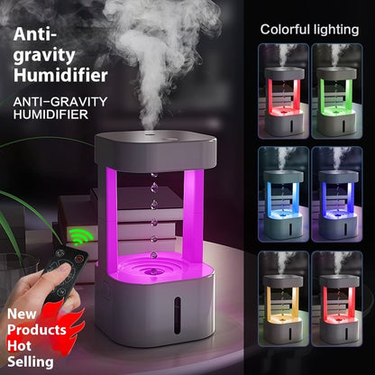 Anti-gravity humidifier with colorful lighting features and a hand holding a remote control.