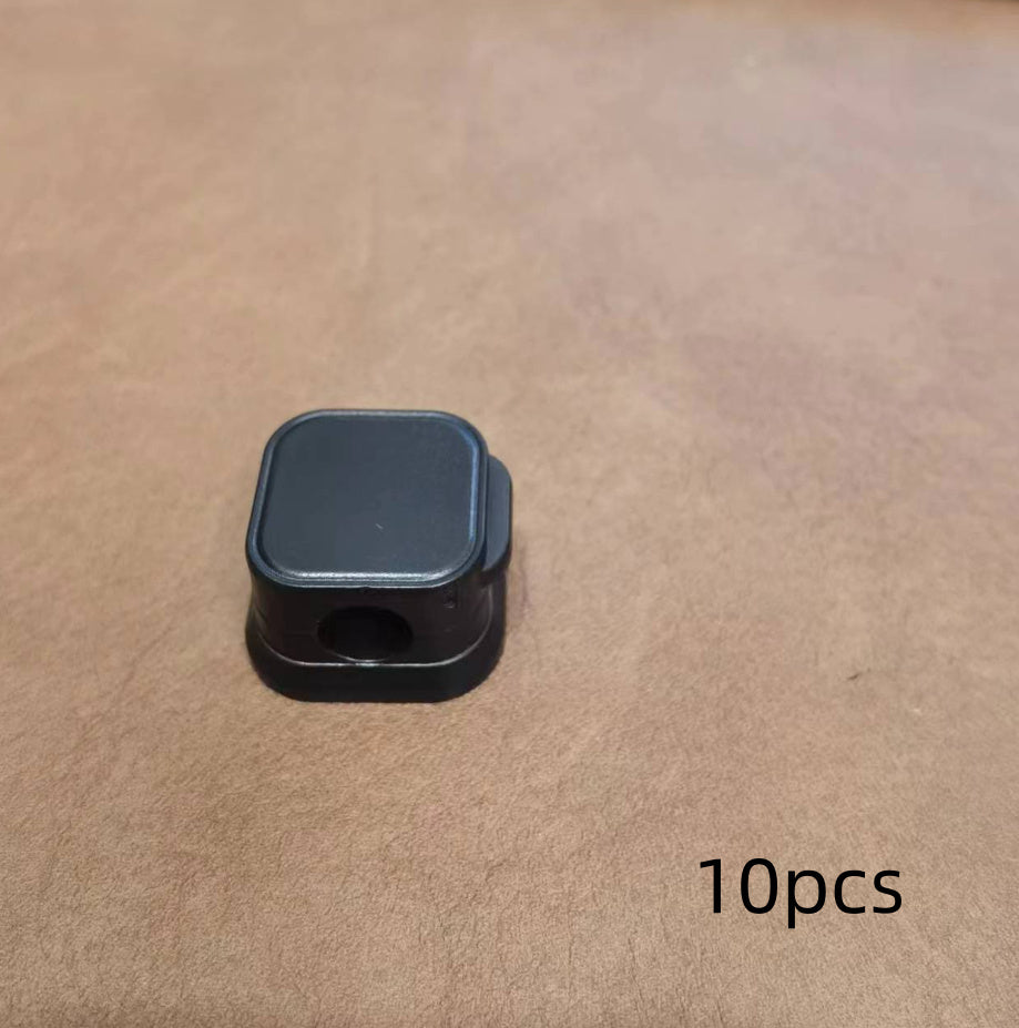 Black square object on a beige surface with '10pcs' text