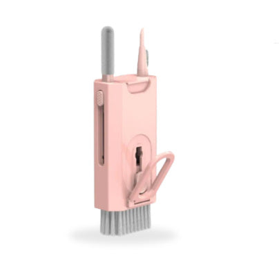 Pink handheld cleaning tool with brush and nozzle on a white background