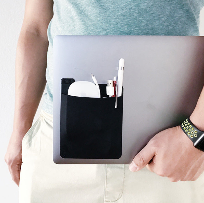 Person holding a laptop with a black pocket attached, containing office supplies.