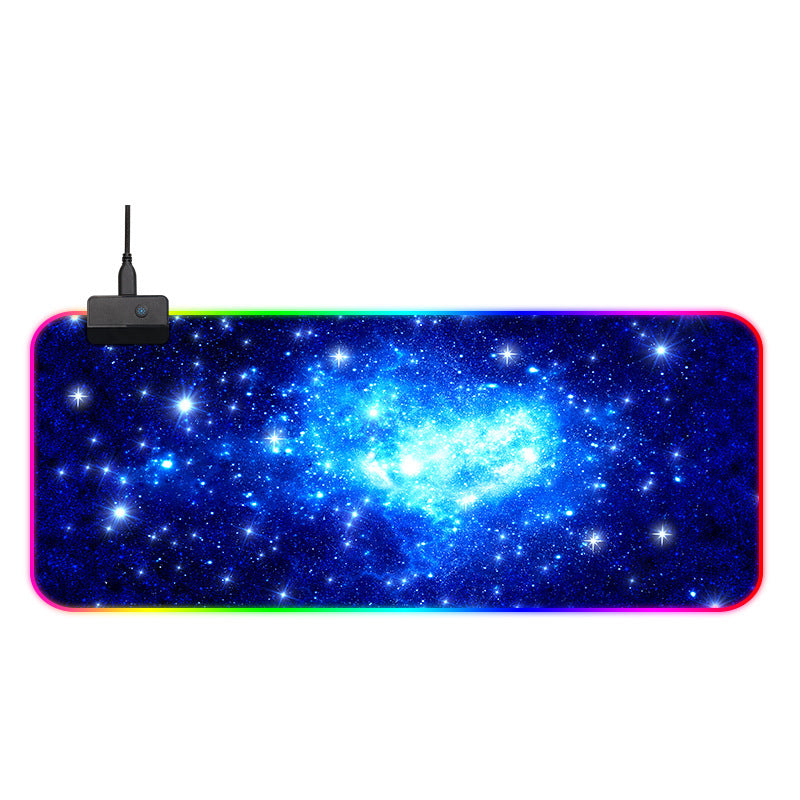 Large mouse pad with galaxy design and USB cable on a white background