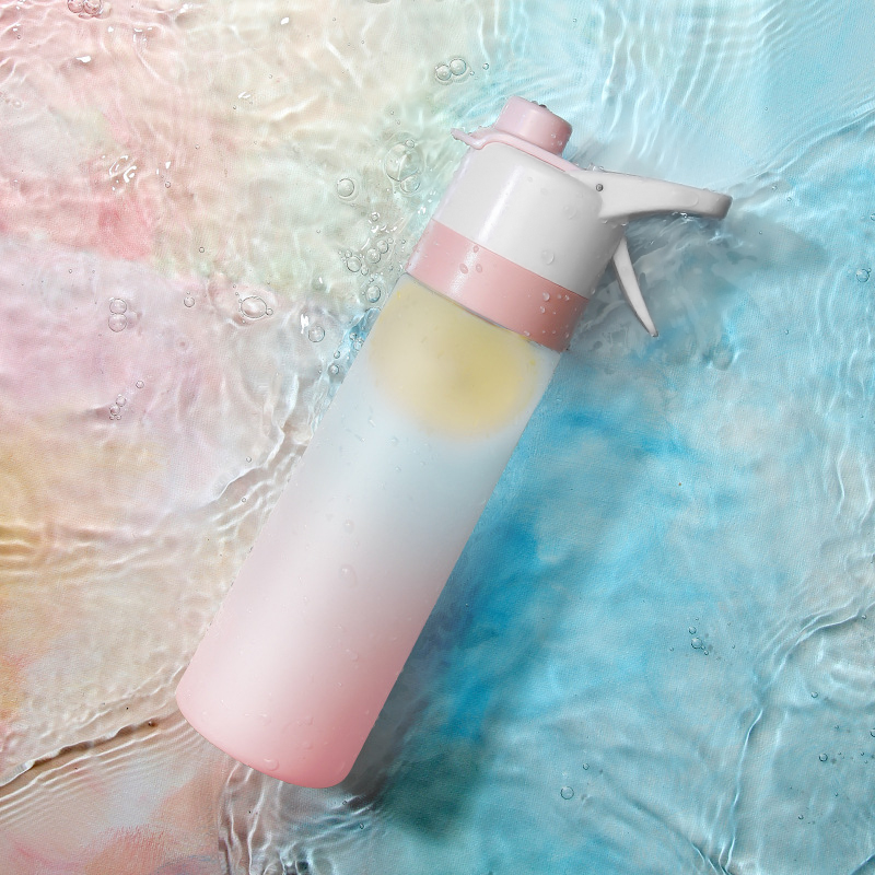 Gradient pink to yellow spray bottle in water with a colorful background