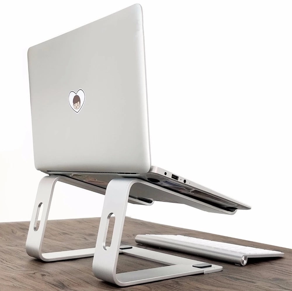 White laptop on a matching white laptop stand on a wooden surface
