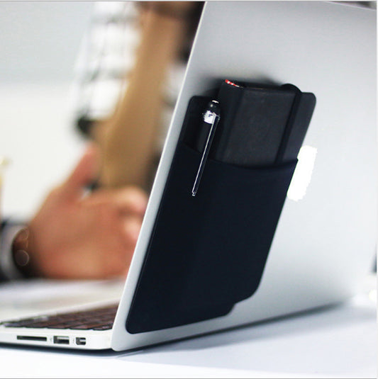Black pen holder attached to a laptop with a blurred background