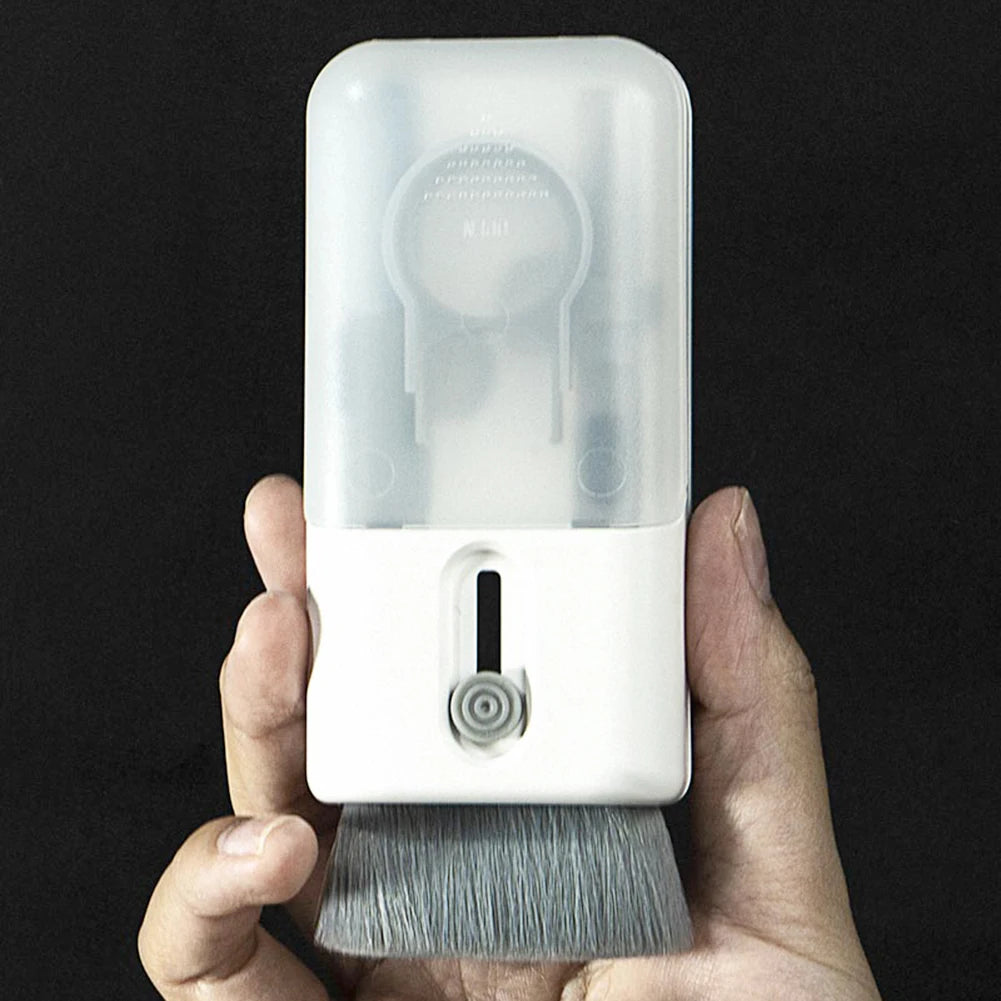 Hand holding a white cleaning brush with a transparent cover against a black background