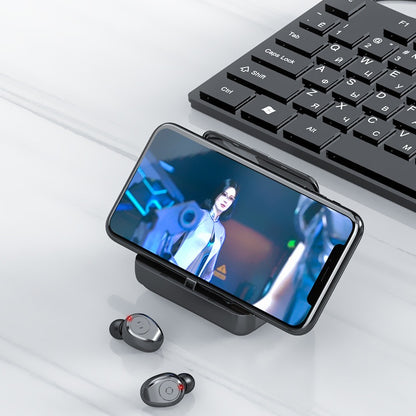 Smartphone with a video call on screen, wireless earbuds, and keyboard on a light surface