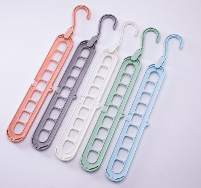Set of five colorful hangers on a light gray background