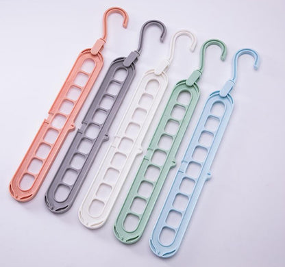 Set of five colorful hangers on a light gray background
