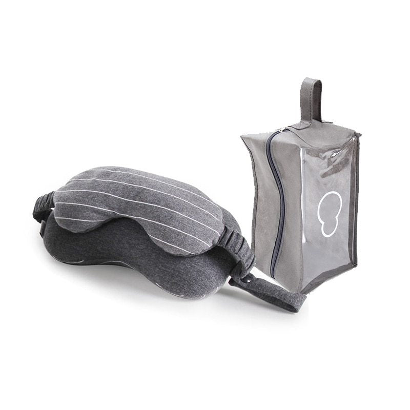 Gray sleep mask with clear carrying case on a white background