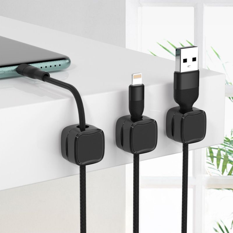 Three black cable organizers with USB connectors on a white surface.