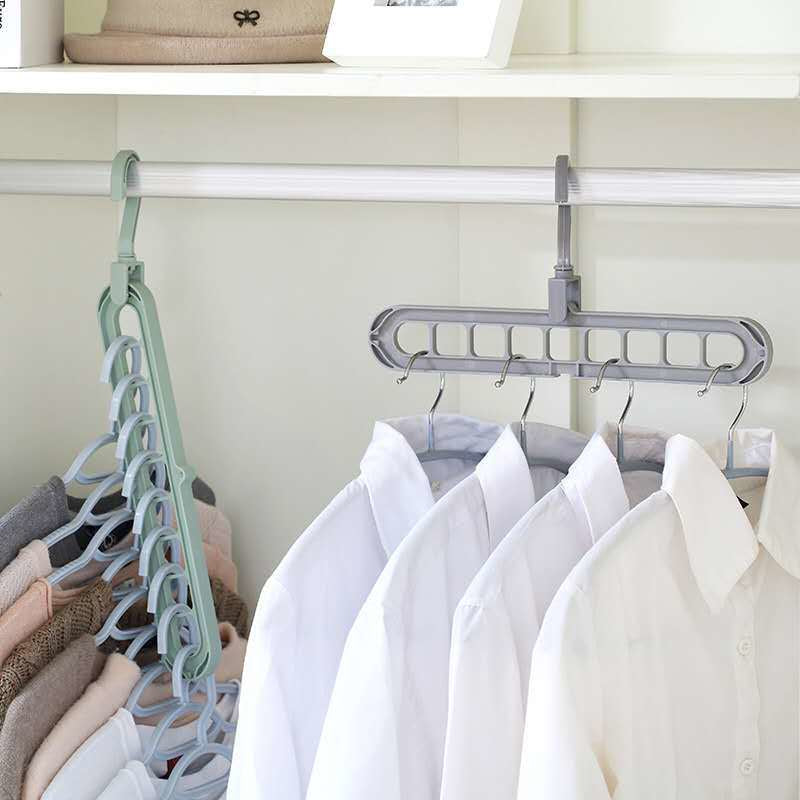 Clothing hangers with multiple hooks on a closet rod, holding shirts.