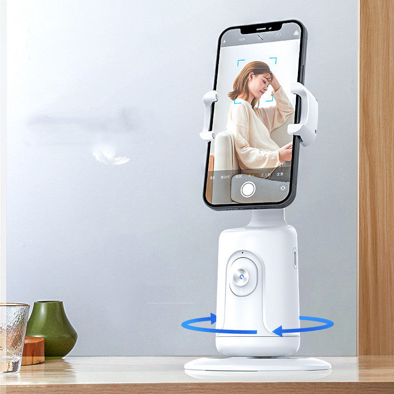 White phone stand with smartphone displaying a video call on a blurred background