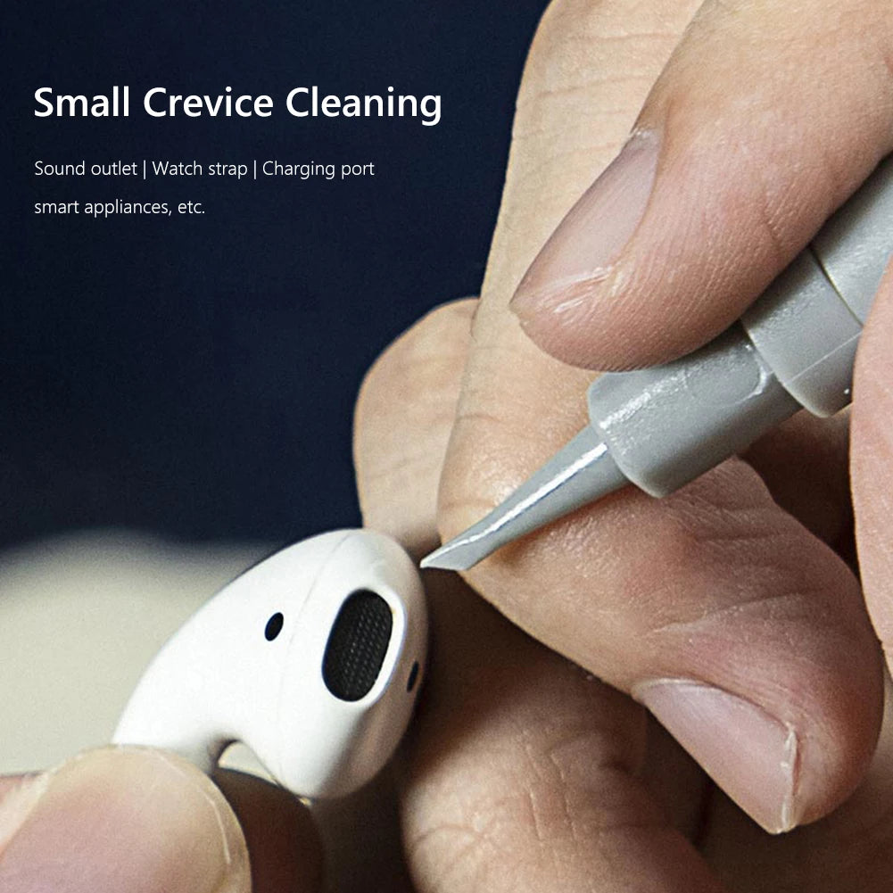 Small crevice cleaning tool being used to clean earbud and electronic device.