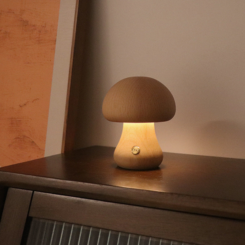 Mushroom-shaped lamp on a wooden surface with a warm glow