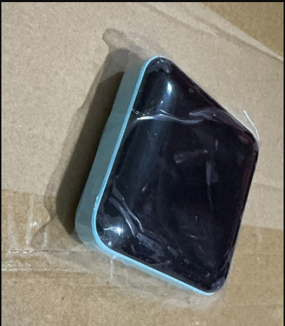 Black object in a clear plastic bag on brown cardboard