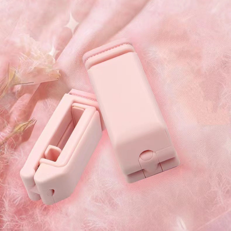 Pink hair clips on a soft pink background