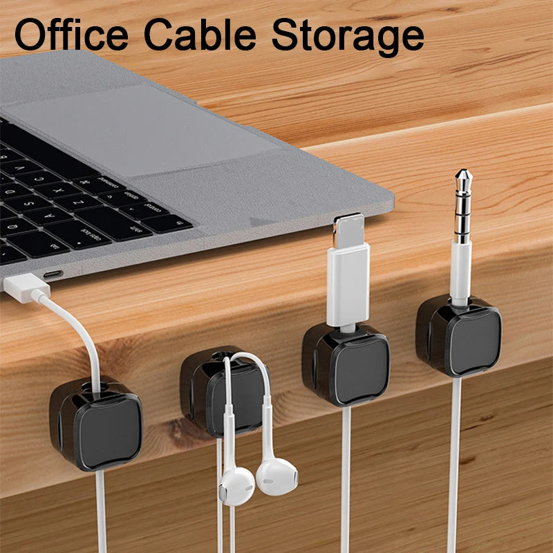 Laptop on a desk with cable organizers holding various cables.