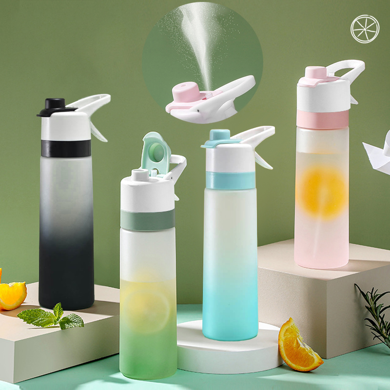 Set of gradient water bottles with colorful caps on a green background