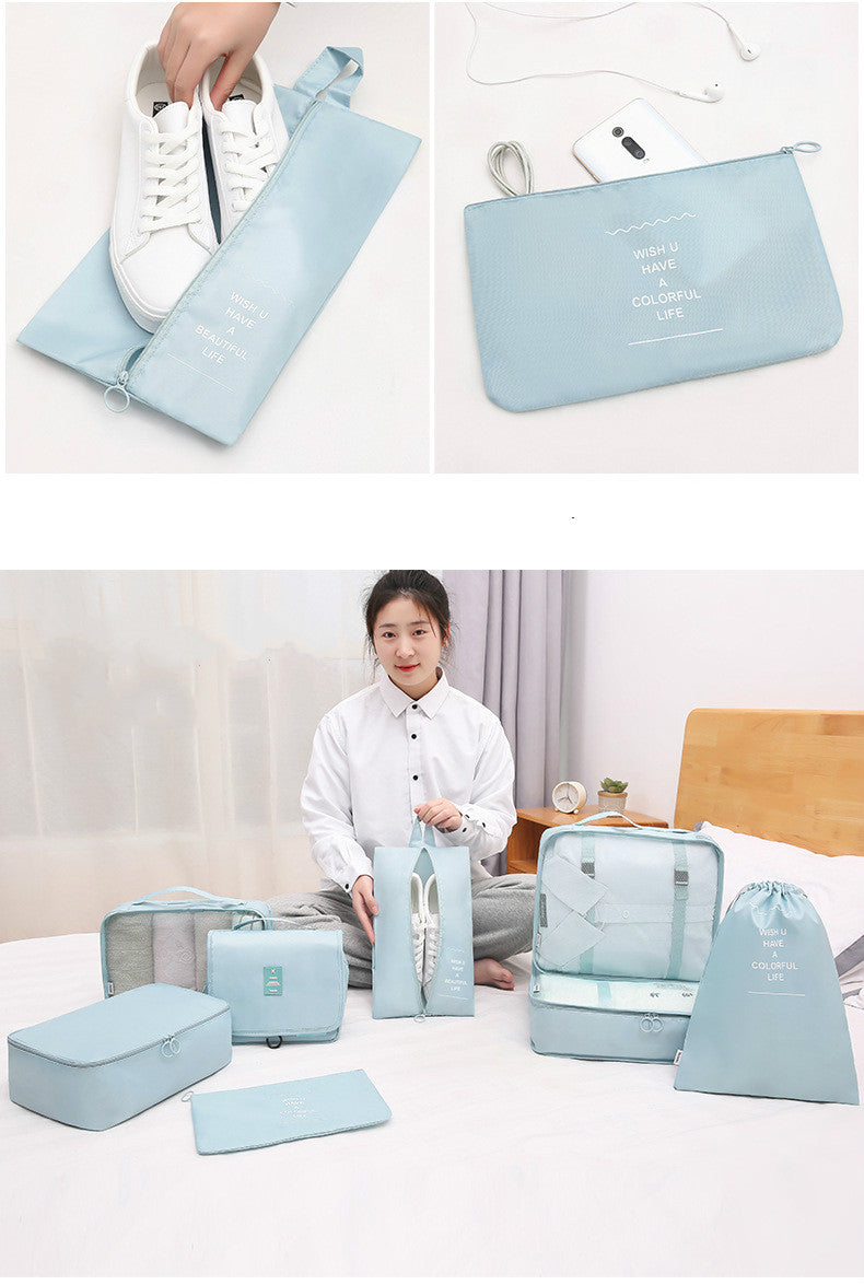 Set of light blue travel bags and pouches with a person organizing them.