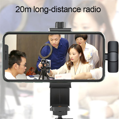 Phone with a ring light and tripod on a stand, displaying a video call with people in a meeting.