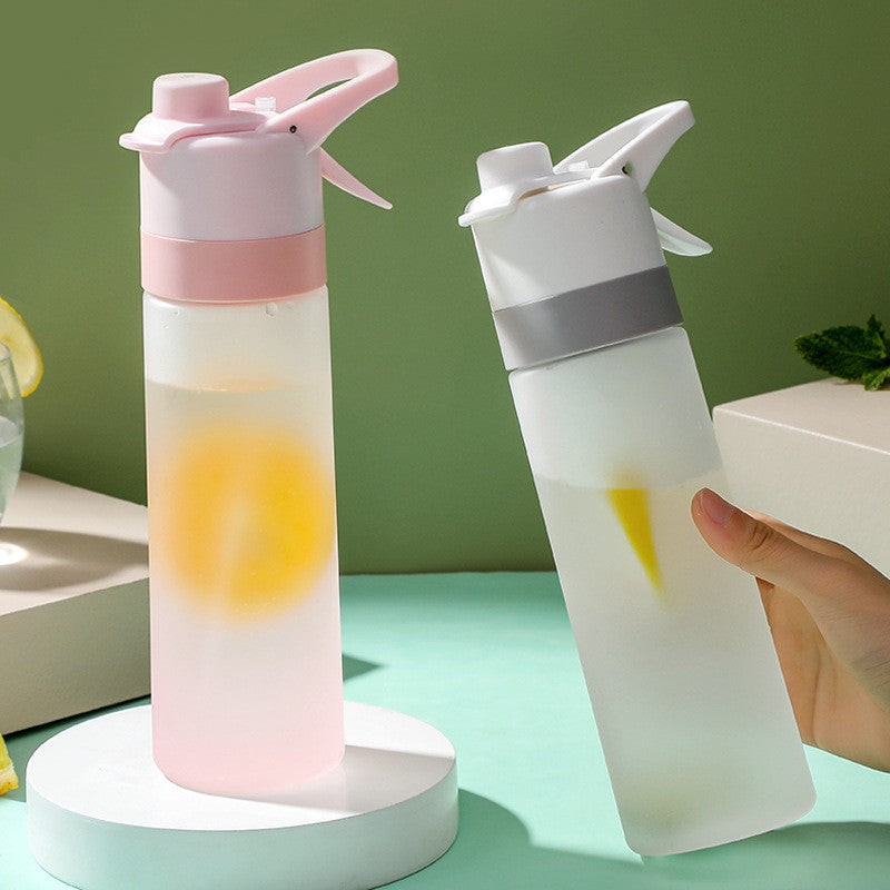 Two colorful water bottles with a hand holding one against a green background