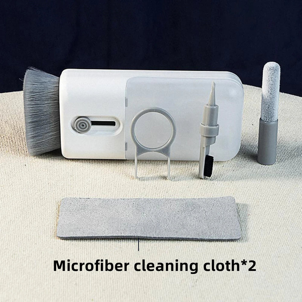 Set of cleaning tools including a brush, cloth, and other accessories on a neutral background.