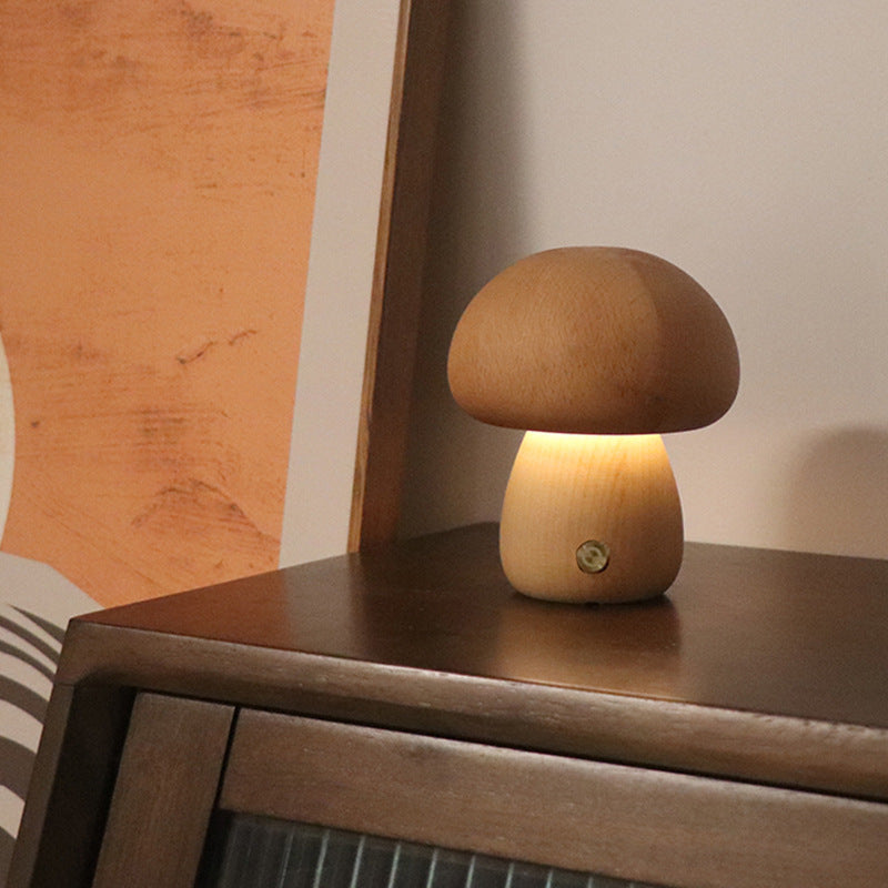 Wooden mushroom lamp on a wooden surface with a warm glow