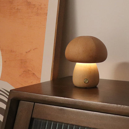 Wooden mushroom lamp on a wooden surface with a warm glow