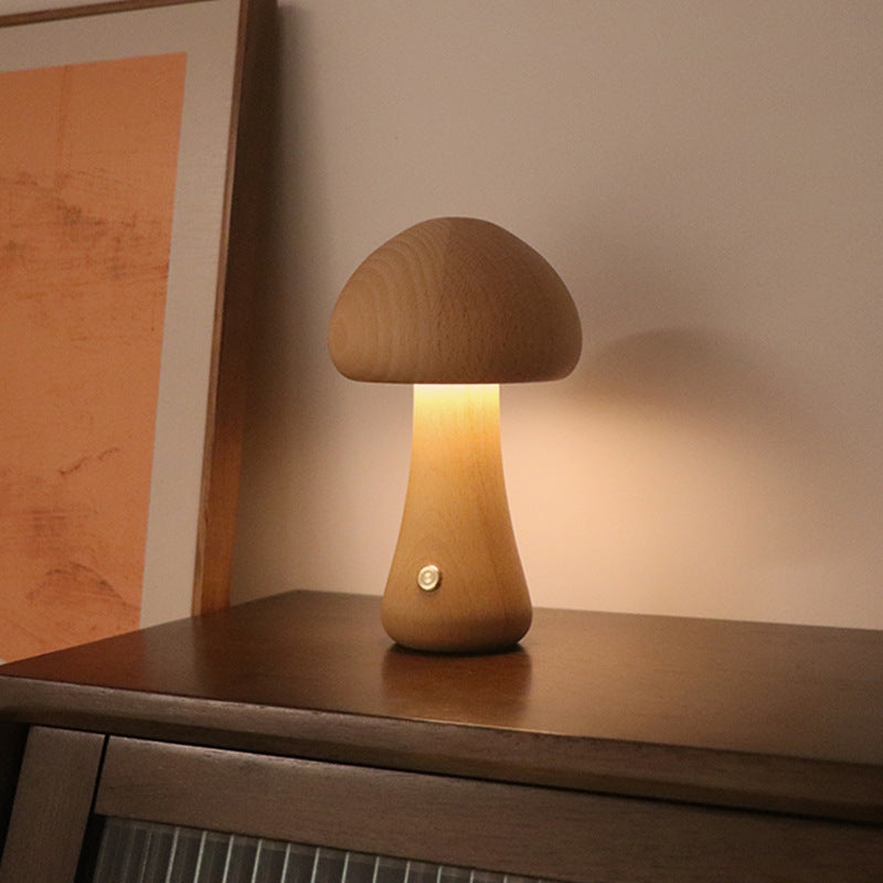 Wooden mushroom lamp on a wooden surface with warm glow