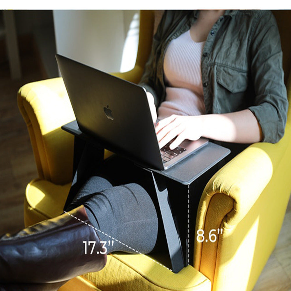 Person using a laptop on a stand with measurements indicated, sitting on a yellow chair.