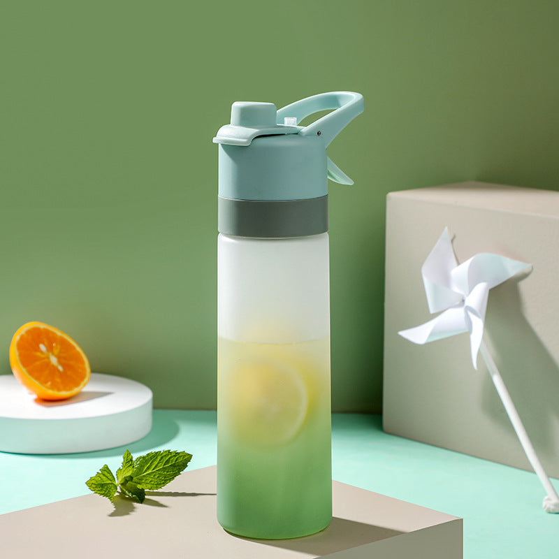 Gradient water bottle with a green base and blue top on a light green background