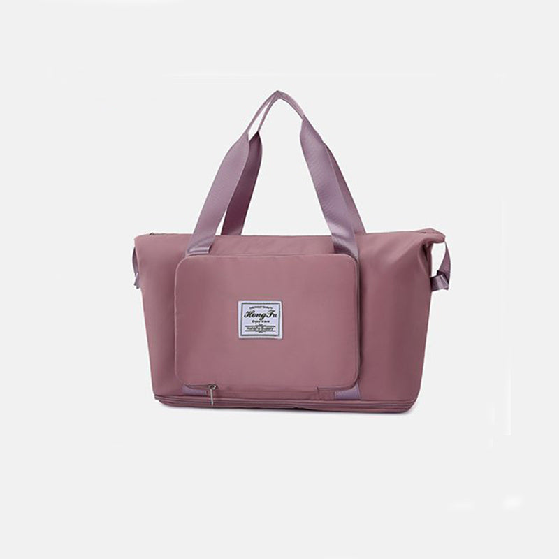 Pink tote bag with a visible brand label on a light gray background