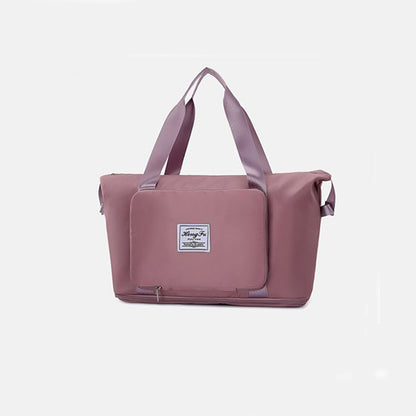 Pink tote bag with a visible brand label on a light gray background