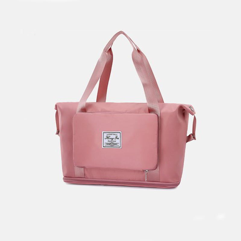Pink tote bag with a visible brand label on a light gray background