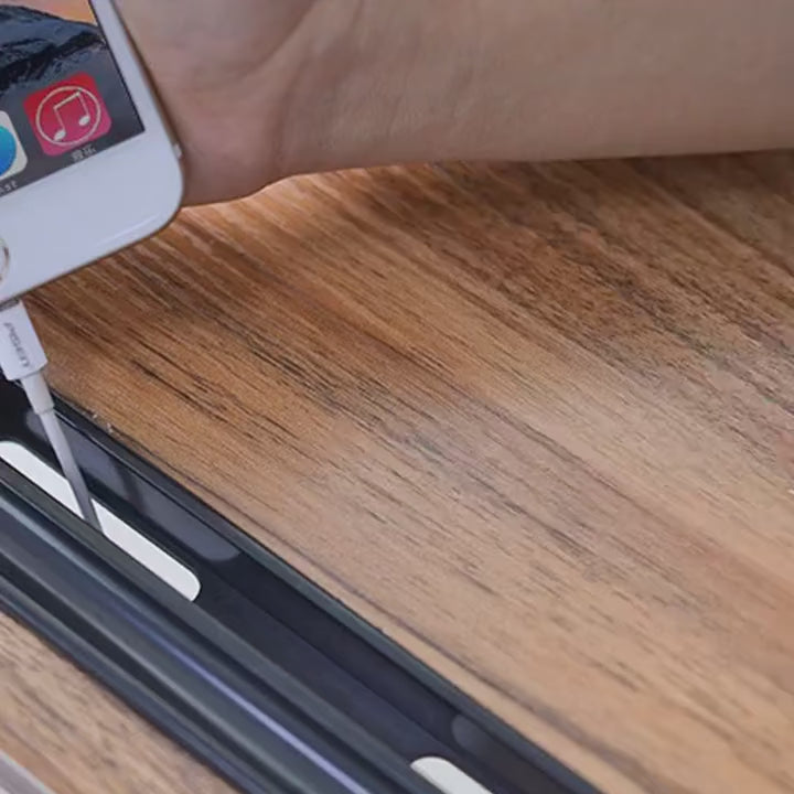 Portable bed side table with movable roller and adjustable height in a bedroom setting.